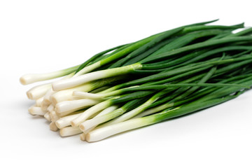 bunch of green fresh onions on a white background