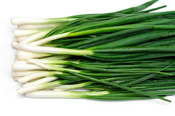 bunch of green fresh onions on a white background