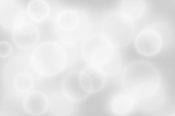 Silver bokeh background. Glowing lights with sparkles. Holiday decorative effect.