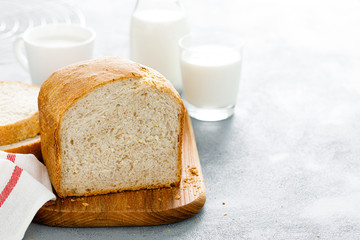 Homemade white wholegrain bread sliced on wooden board