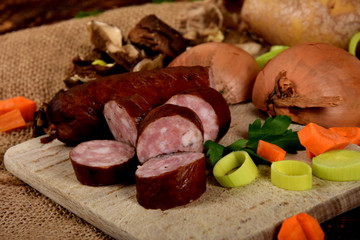 Polish smoked sausage sliced on a wooden board