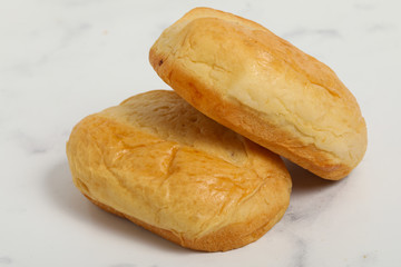 Breakfast buns on white marble background. Sweet brioche