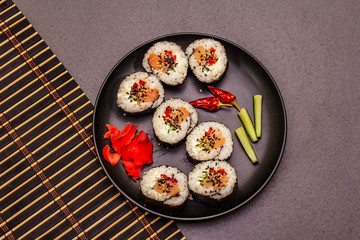 Korean roll Gimbap(kimbob). Steamed white rice (bap) and various other ingredients. Trendy black background