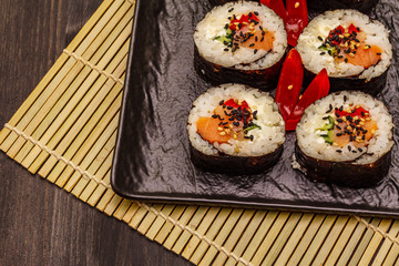 Korean roll Gimbap(kimbob). Steamed white rice (bap) and various other ingredients. Trendy black background
