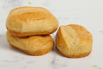 Breakfast buns on white marble background. Sweet brioche