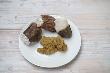 Glutinous rice steamed cooked with coconut milk in pitcher plants known as lemang periuk kera with spicy chicken rendang. A traditional malay cuisine during Hari Raya festival.