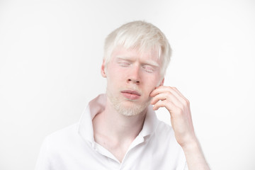 portrait of an albino man in  studio dressed t-shirt isolated on a white background. abnormal deviations. unusual appearance