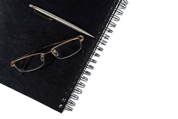 notebook, glasses and pen