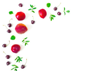 Peaches with cherry and mint leaves on white background. Summer food frame. Top view