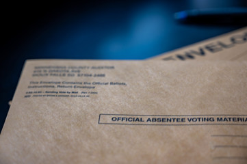 Selective focus on brown official absentee ballot voting material envelope