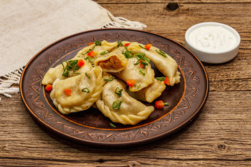 Dumplings stuffed stewed cabbage and sour cream. Traditional Ukrainian dish varenyky