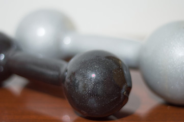 black and gray dumbbells for exercising at home, with different weights