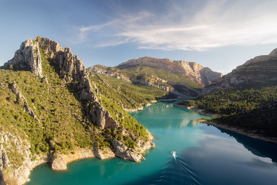 Boat across Mont Rebei canyon in the morning, Lleida, Spain