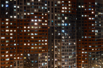 Fototapeta na wymiar Butovo Park, Leninsky district of Moscow region, Russia-2020 . An area with numerous residential buildings. Suburbs. Suburban town in lights. Multicolored light in the Windows. Evening in the city.