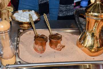 Coffee in metal Turkish traditional cup, being served in a traditional cafe bar in Istanbul, Turkey