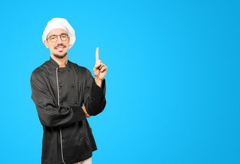 Young chef making a number one gesture