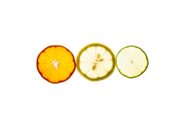 Three slices of lemon, tangerine and lime fruit with light shining through backlight showing the structure and details isolated on a white background