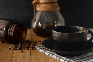 black cup of coffee and coffee beans