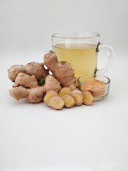 ginger tea, ginger root and powder on white background.