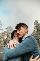 Gay couple in love on a mountain road