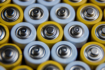 The batteries stand close together and form a beautiful background. Selective focus. Artistic...