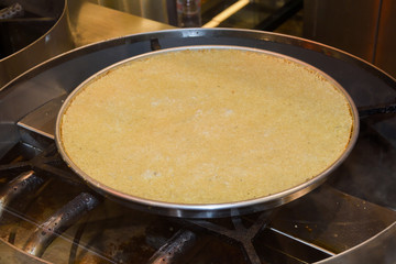 Turkish dessert kunefe with pistachio powder. Kunafa, kadayif with pistachio powder and cheese hot