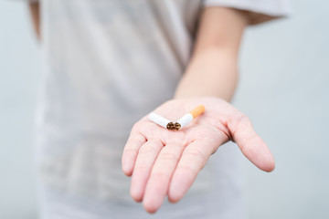 Stop smoking and Quit smoking cigarettes concept. Portrait of beautiful  girl holding broken...