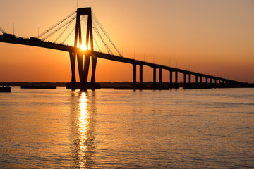 Naklejka na ściany i meble Bridge seen from the coast during sunset