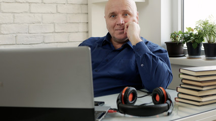 Man Working from Home and Talking in a Video Call Using Laptop Webcam and Headphones, Social...