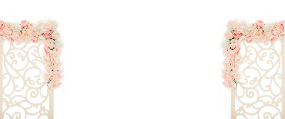 White wooden gates with patterns and compositions of flowers. Wedding arch decorated with white and pink roses