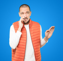 Concerned young man with a gesture of disgust