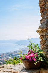 Panoramic view of a Mediterranean bay from a stone arch of a medieval village in the Ligurian Riviera, Borgio Verezzi, Liguria, Italy