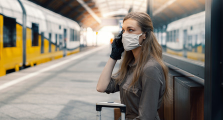 Woman wearing white protective face mask is using public transportation during the epidemic outbreak