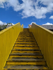 yellow wooden stairs leading to the sky