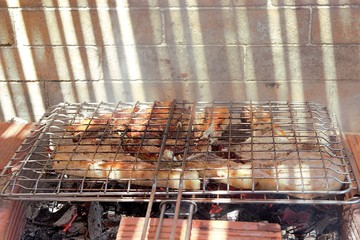 Roast steak on a barbecue, shallow depth of field. Closeup, summer bbq in an outdoor grill