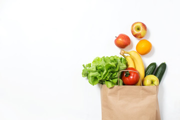 Food delivery. Paper bag with vegetables and fruits on a white background. Online order from the...