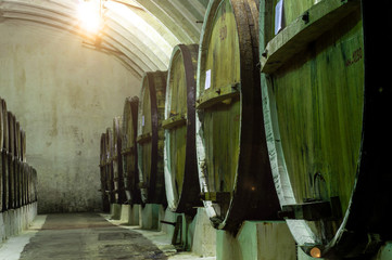 Big old barrels in the vault cellar. wine ripening and storage technology.