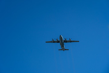 Fototapeta na wymiar One aircraft of russian air forces is flying at airshow on bright blue sky