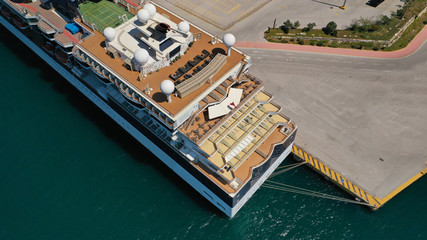 Fototapeta na wymiar Aerial drone photo of huge luxury cruise liner docked in Mediterranean port