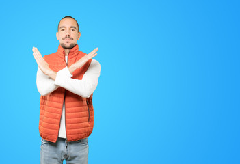 Young man making a gesture of not crossing with the arms