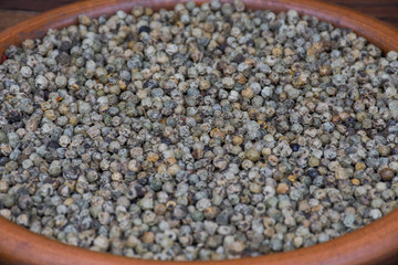 Mixed peppercorns background. Different colored peppercorns, close up.