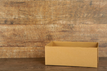 Cardboard box on the broun background. Copy space