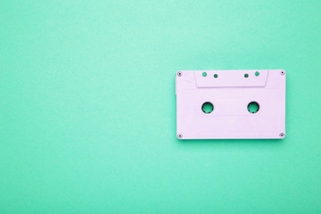 Old audio cassette on mint background. Music day