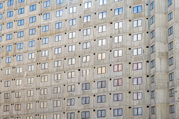  construction of an apartment building, building a monolithic concrete house with many windows, many plastic windows on the facade of a building under construction, commissioning
