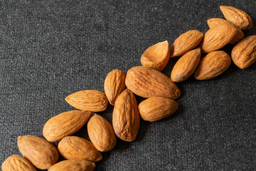 almonds on a black and grey background