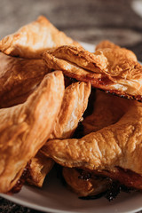 home made puff pastry buns. Triangular in shape with caramelized sugar. On a white plate. Close