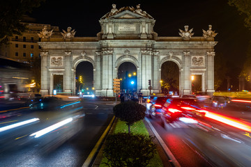Fototapeta premium Night traffic at historical landmark Alcala Gate in Central Madrid, Spain.