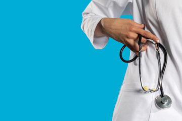 Stethoscope in a hand held by a young GP.