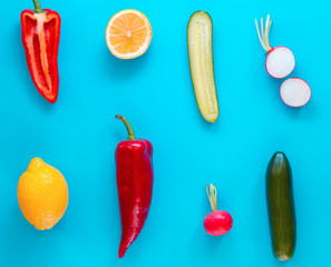 Flat lay top view of fresh vegetables over pastel blue backdrop with minimal style, copy space