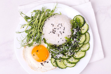 Rice with cucumber, scrambled eggs, microgreen and Japanese wakame seaweed salad.